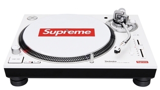 Photo of a white technics DJ turntable with a red supreme logo