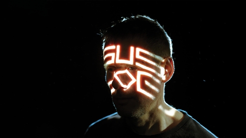Photo of Clark with ‘Sus Dog’ projected onto his face in futuristic writing