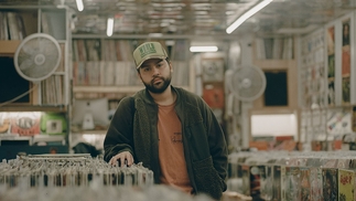 Marco Weibel standing in a record store by Filipe Zapelini (@zapelini)