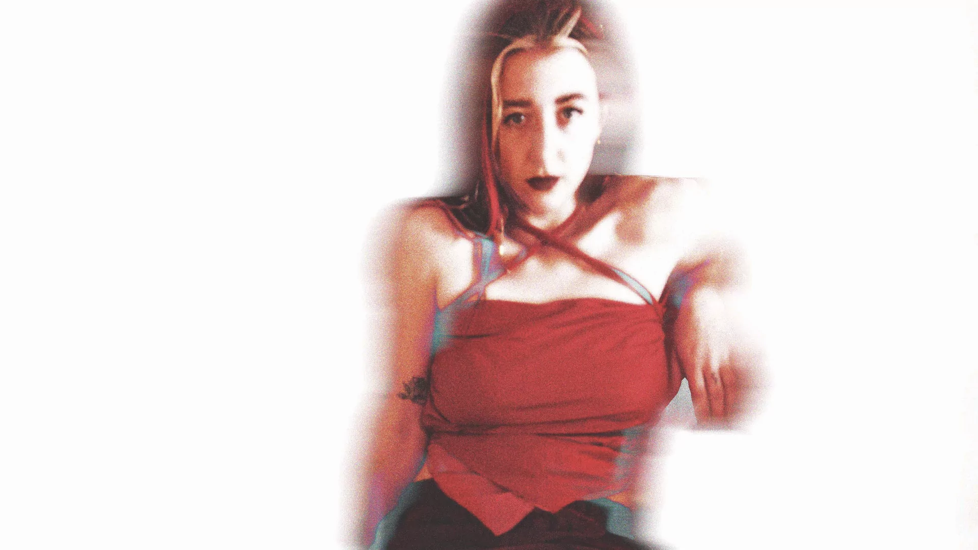 Glitchy photo of ex.sses wearing a red corset dress