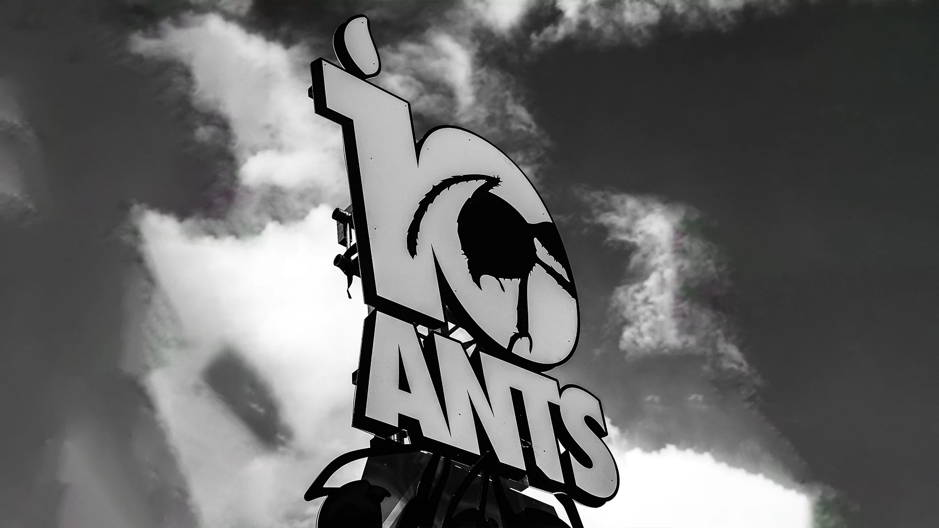 Black and white photo of the tenth anniversary ANTS sign against the sky
